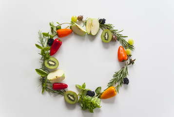 Wreath of vegetables and fruits with empty text space on white background