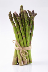 green asparagus sprouts over white background