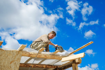 workers make a roof in a country house