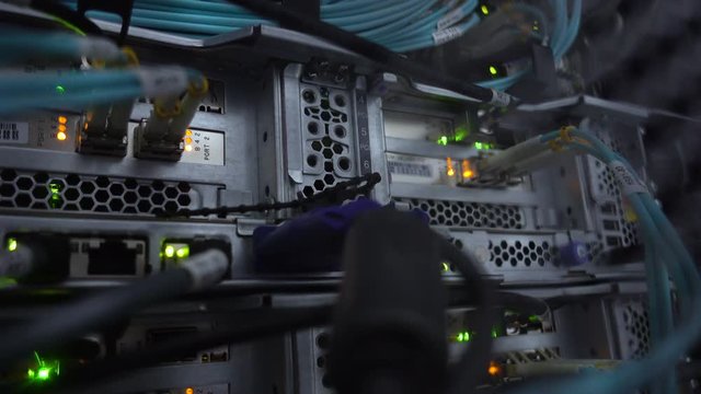 4K. Optical server working dark data servers. Blinking led green lamps. CloseUp. The video contains a little noise
