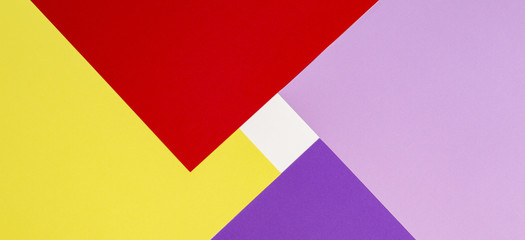 Color papers geometry flat composition background with violet, purple, pink, red, yellow tones.