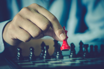man hand playing chess board, concept of business strategy and tactic