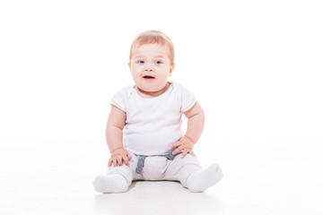 smiling baby sitting on a floor
