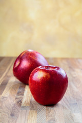 Fototapeta na wymiar two ripe apples lie on the oak surface of the table