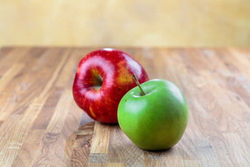 two ripe apples lie on the oak surface of the table
