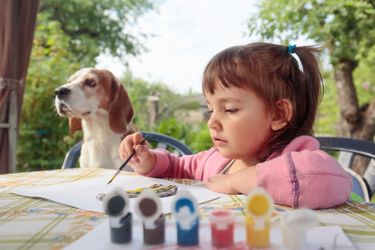 Cute little girl paints animal figures