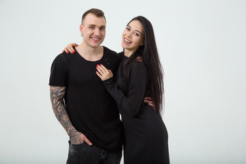 Couple in love. Modern stylish man and woman embrace and smile.