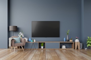 TV on the cabinet in modern living room with armchair on dark wall background,3d rendering