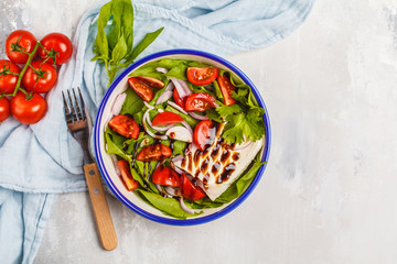 Bright summer salad with goat cheese feta, tomato, red onion and balsamic on a white background, copy space