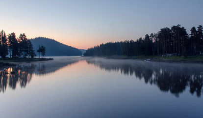 Magic sunrise by the dam lake in Rhodope mountain, Bulgaria. 