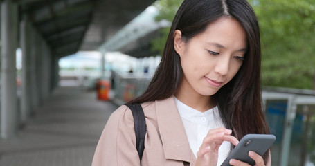 Woman work on mobile phone in city