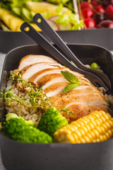 Healthy meal prep containers with grilled chicken with fruits, berries, rice and vegetables. Takeaway healthy food.