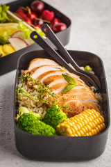 Healthy meal prep containers with grilled chicken with fruits, berries, rice and vegetables. Takeaway healthy food.