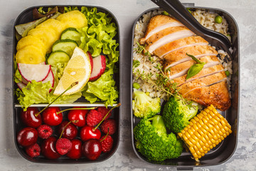 Healthy meal prep containers with grilled chicken with fruits, berries, rice and vegetables....
