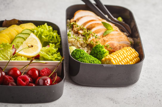 Healthy meal prep containers with grilled chicken with fruits, berries, rice and vegetables. Takeaway healthy food.