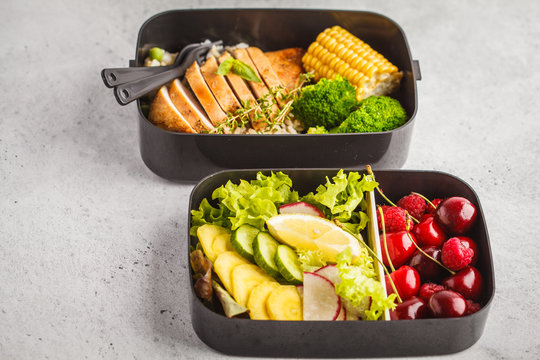 Healthy meal prep containers with grilled chicken with fruits, berries, rice and vegetables. Takeaway healthy food.