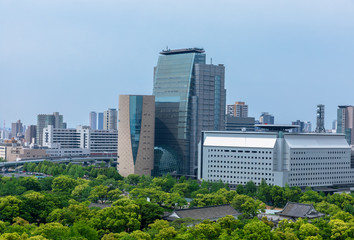 Fototapeta premium Wall and moat around Osaka Castle and skyscrapers of Osaka Busin