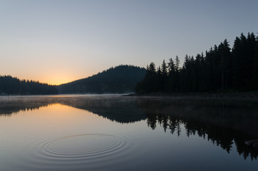 Magic sunrise by the dam lake in Rhodope mountain, Bulgaria. 