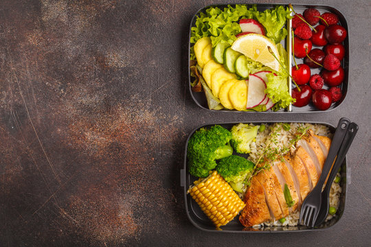 Healthy meal prep containers with grilled chicken with fruits, berries, rice and vegetables. Takeaway food, copy space