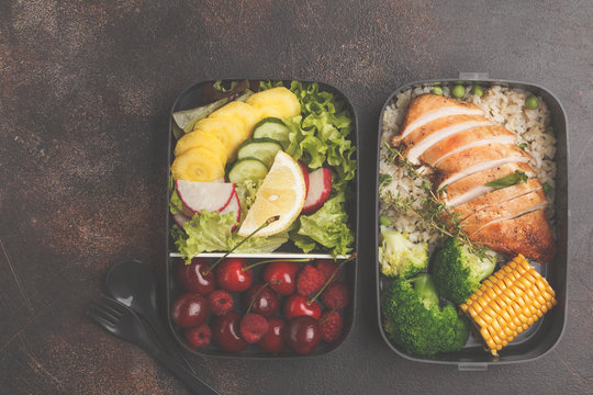Healthy meal prep containers with grilled chicken with fruits, berries, rice and vegetables. Takeaway food, copy space