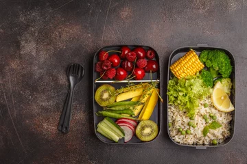 Poster Healthy vegan meal prep containers with brown rice, broccoli, vegetables, fruits and berries overhead shot © vaaseenaa