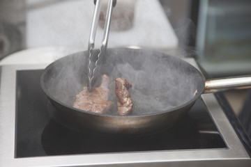 Hands chef cooking lamb