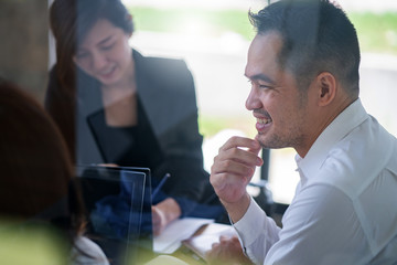 Business partners showing team work while working in meeting room at office interior Business consultant concept. Team work and successful project.