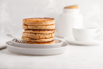 Homemade pancakes with chia seeds on a white plate, white background. Healthy vegan food concept.