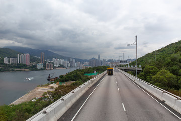 Tsing Yi North Coastal Road in Tsing Yi island connect to New Territories in Hong Kong with Sea mountain rang and city background