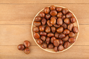 Top view angle of chestnut in wooden plate