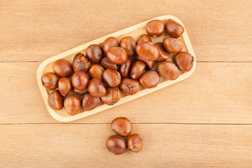 Top view angle of chestnut in wooden plate