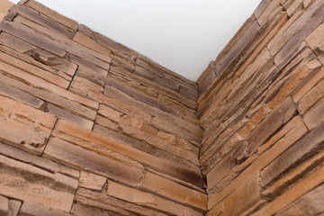 Sample of a decorative stone wall. Details of the corner ceiling, bricks texture