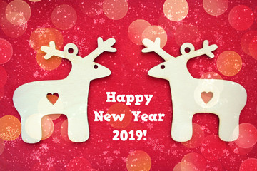Two identical Christmas deer on a textured red background with falling snowflakes.Free space for text. Christmas or new year card