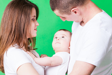 Obraz premium Portrait of young couple and their cute baby