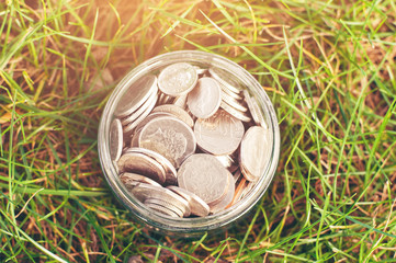 Top view of jar with coins (toned)