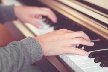 Closeup view of hands playing the piano (shallow depth of field)