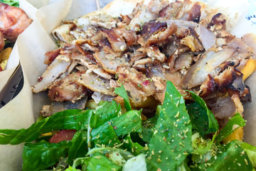 Meat donner on flat pita bread with salad