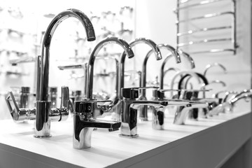 Rows of new faucets in plumbing shop, closeup