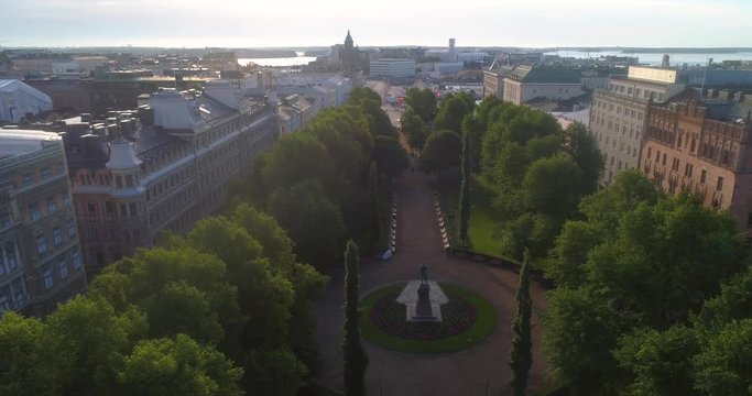 City central park, C4k aerial backward view of Helsinki esplanadi park, on a sunny summer morning dawn, in Helsingfors, Uusimaa, Finland