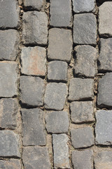 A top view of a paved road pattern. Masonry of the street. Sidewalk tiles.