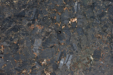 The texture of dark marble. An old marble, granite wall.
