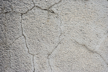 Light gray plaster with cracks. Beautiful wall texture