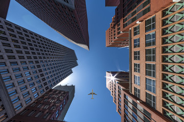 Fototapeta na wymiar A plane flying over the modern blue cubic buildings located at The Hague city, Netherlands