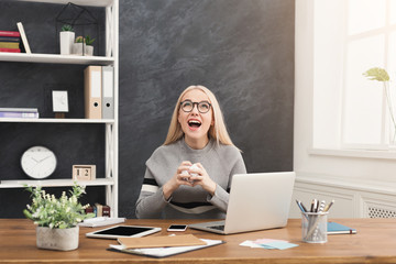 Furious woman working on laptop at office