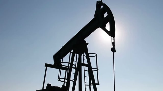 Silhouette Of Pump Jack / Pump jack in action against the shiny sun. HD1080p