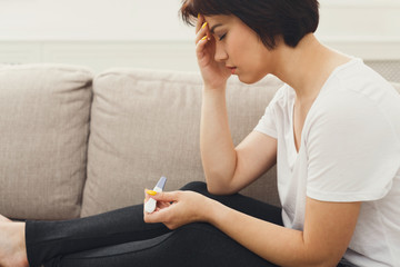 Unhappy girl with recent pregnancy test