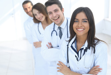 female doctor with group of happy successful colleagues