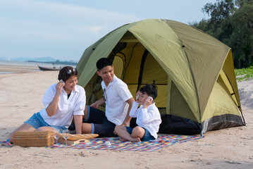 Summer vacation. Family camping on beach with tent.