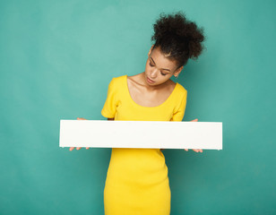 Young african-american woman holding blank banner
