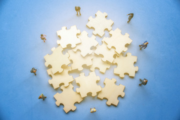 Fototapeta premium Miniature on wood jigsaw, Business concept